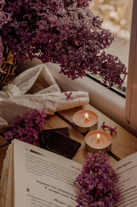white candle beside white book. Calmebrium Routines with intentional rhythms for quiet presence.