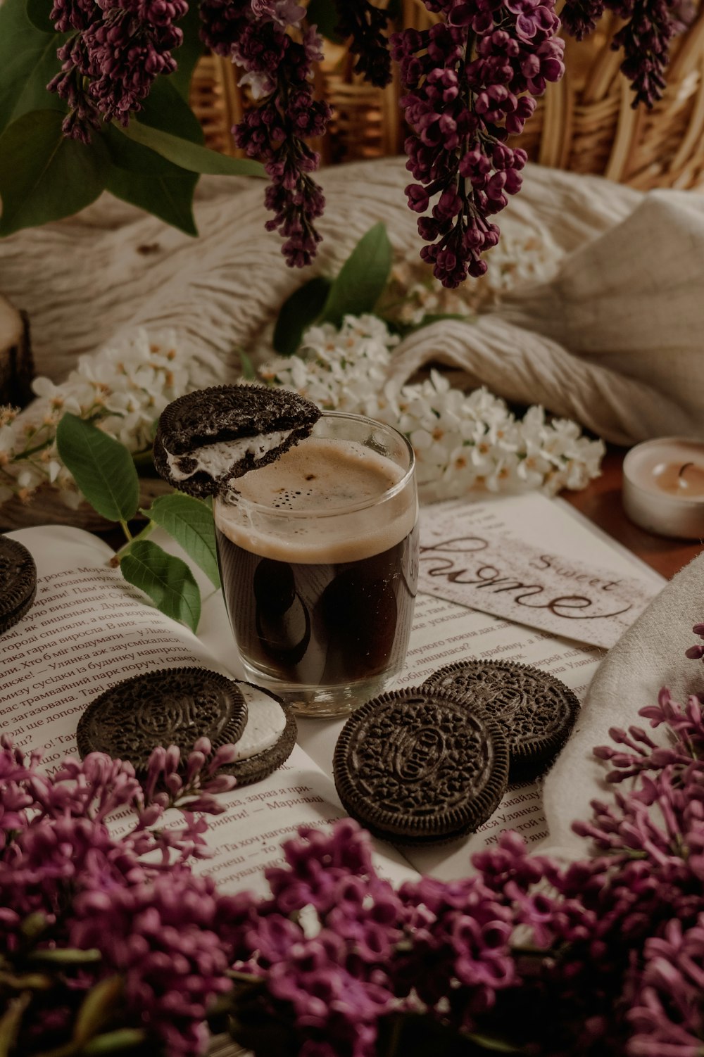 clear drinking glass with brown liquid on brown wooden table