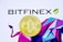 A golden Bitcoin coin is placed against a background with the word 'Bitfinex' in bold black letters and a geometric pattern of multicolored shapes. The Bitcoin symbol is prominently centered in the metallic coin.