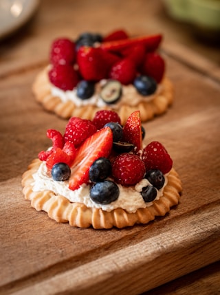 strawberry and blueberry pie on brown wooden table