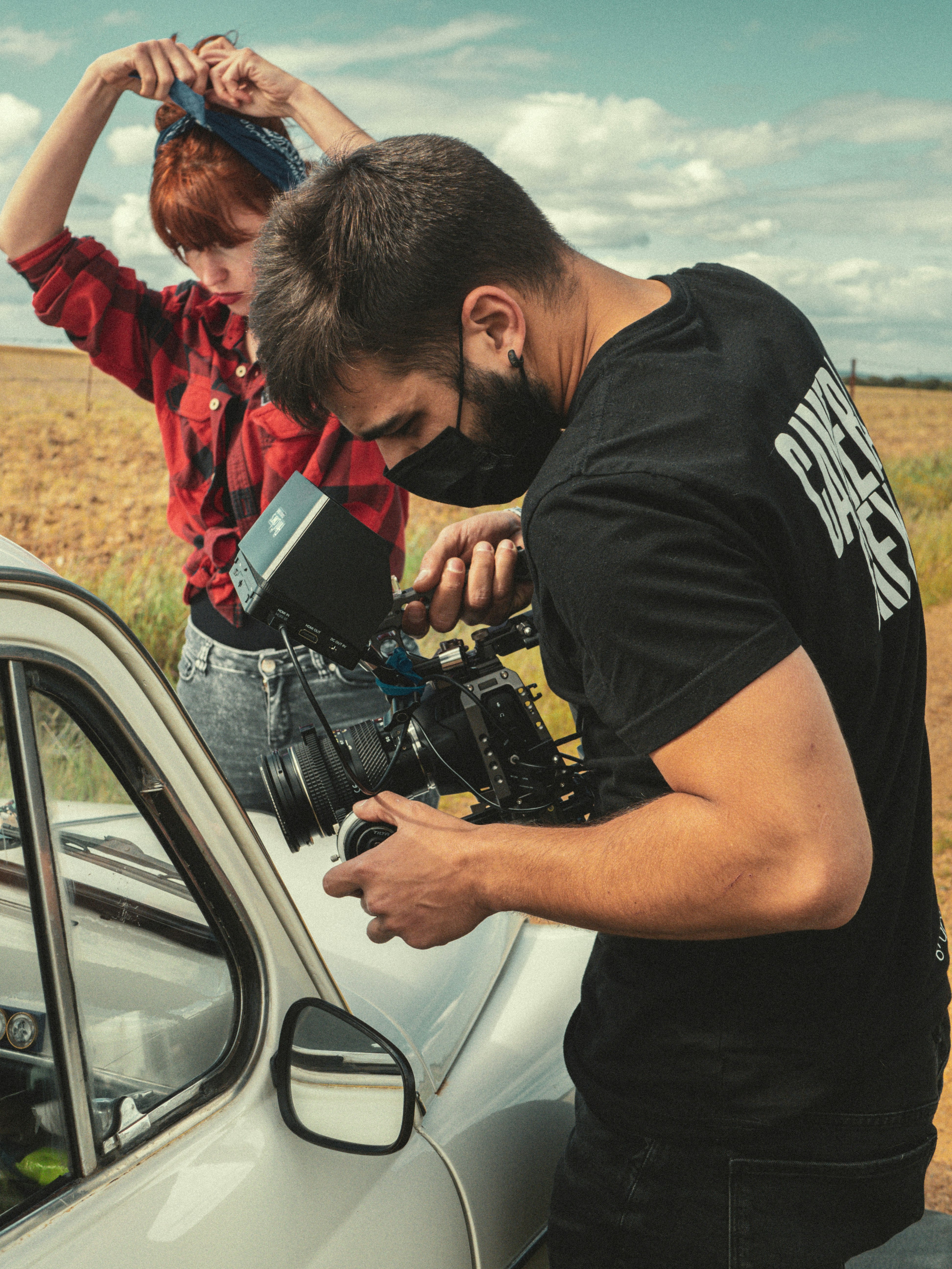 man in black crew neck t-shirt holding black dslr camera