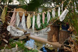 A backyard transformed with jungle-themed cardboard cutouts and green streamers.