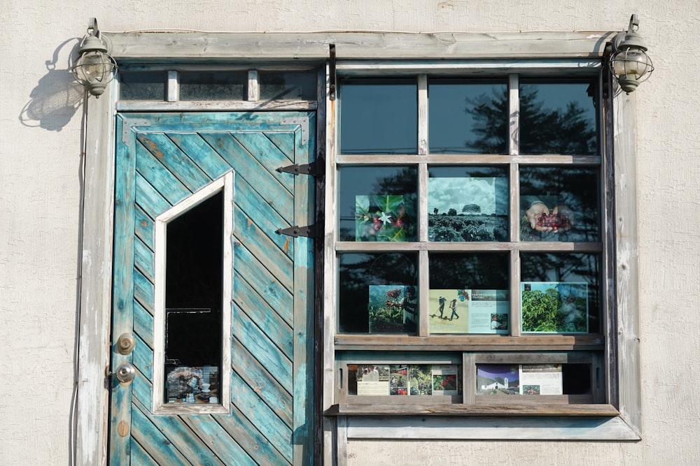 blue wooden framed glass window