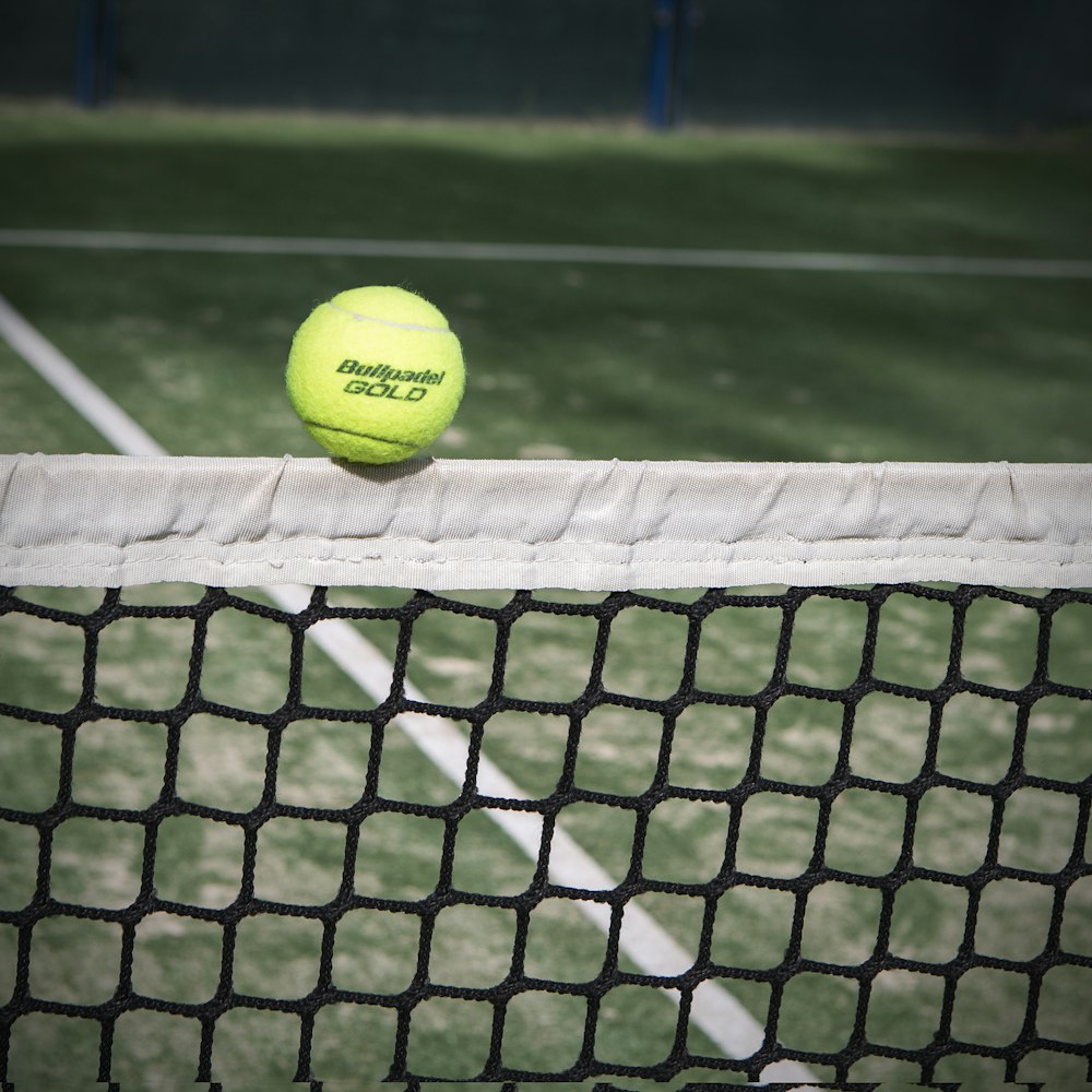 yellow tennis ball on tennis court