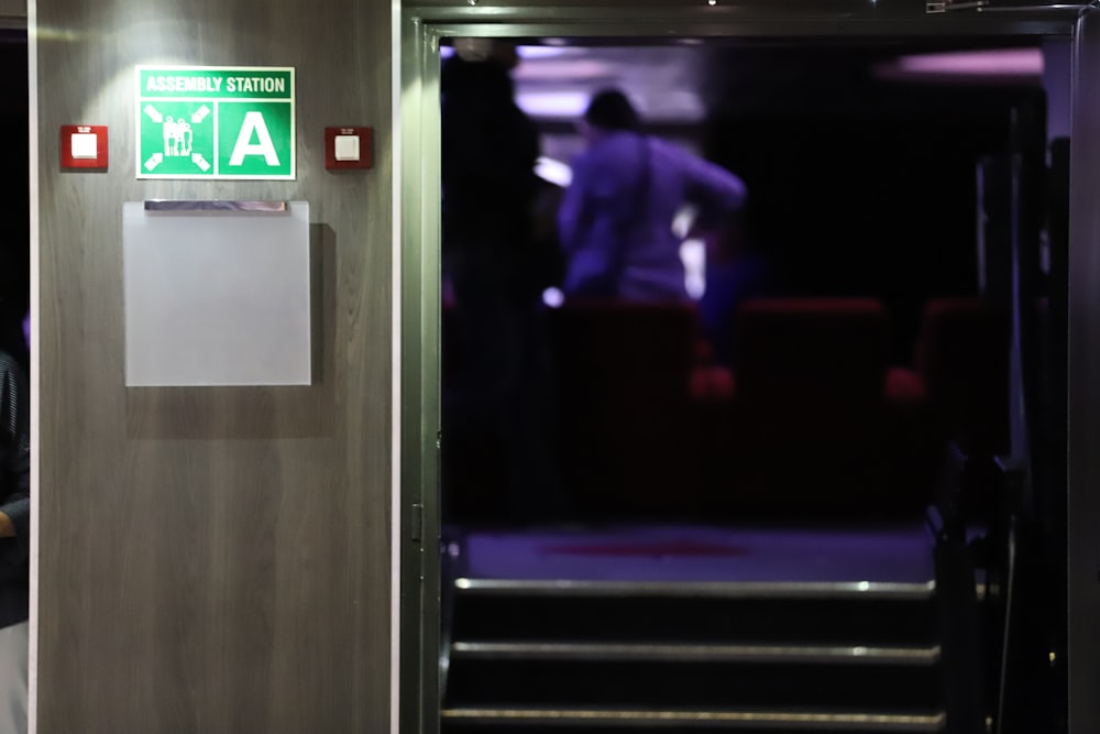 man in black suit jacket standing near elevator