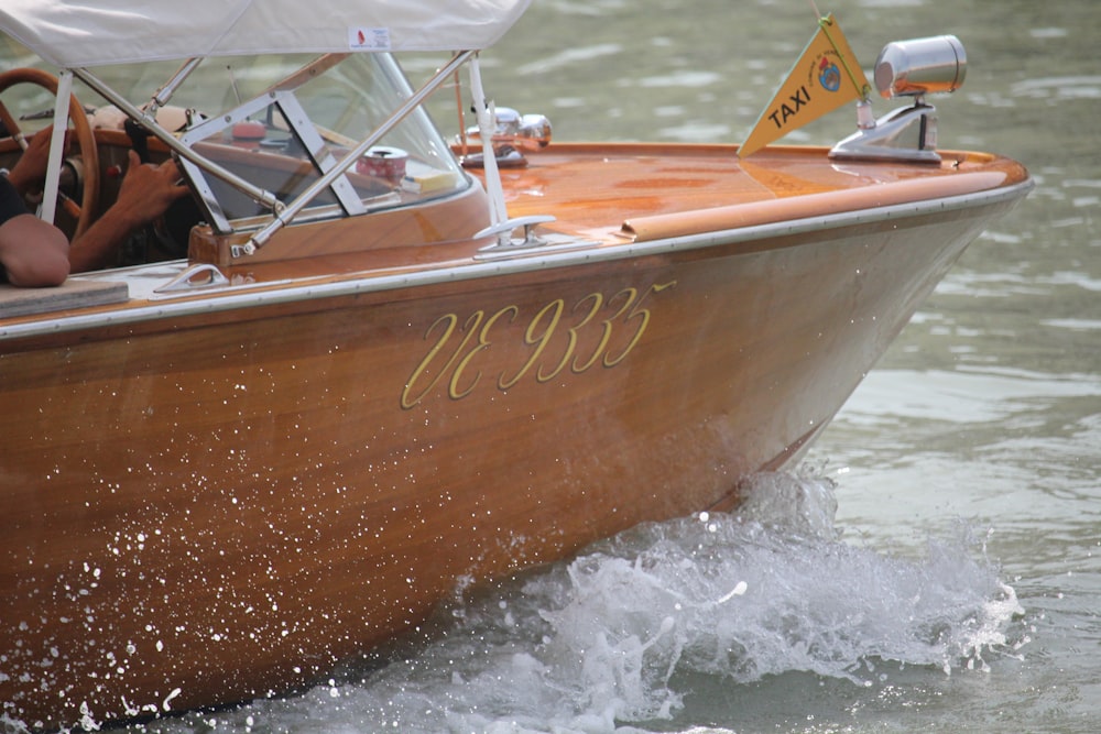 brown and white boat on water during daytime