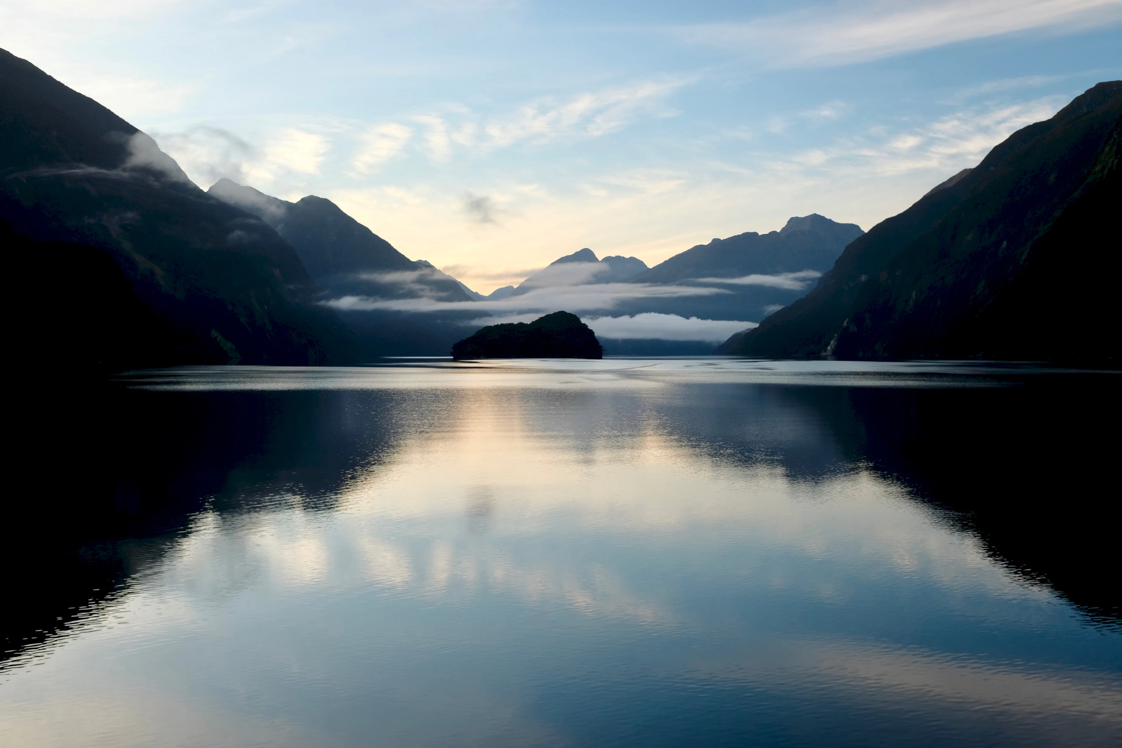 Dawn on Doubtful Sound, Fiordland: still water and layered mountain silhouettes