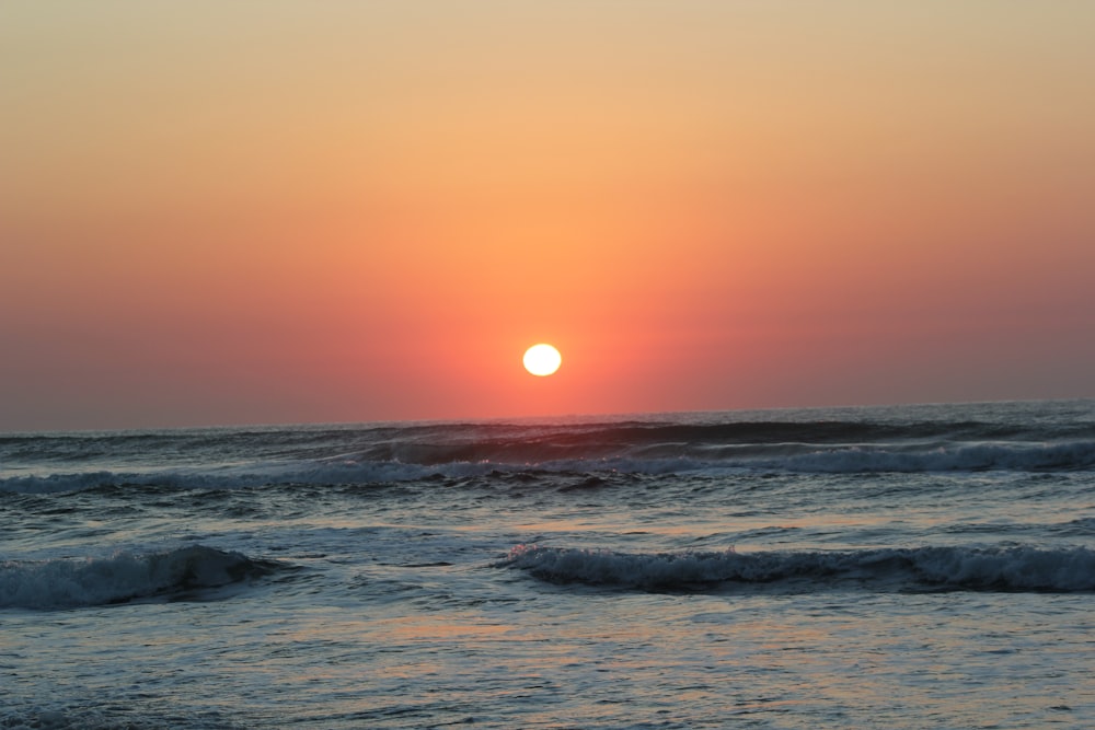 ocean waves during sunset on beach
