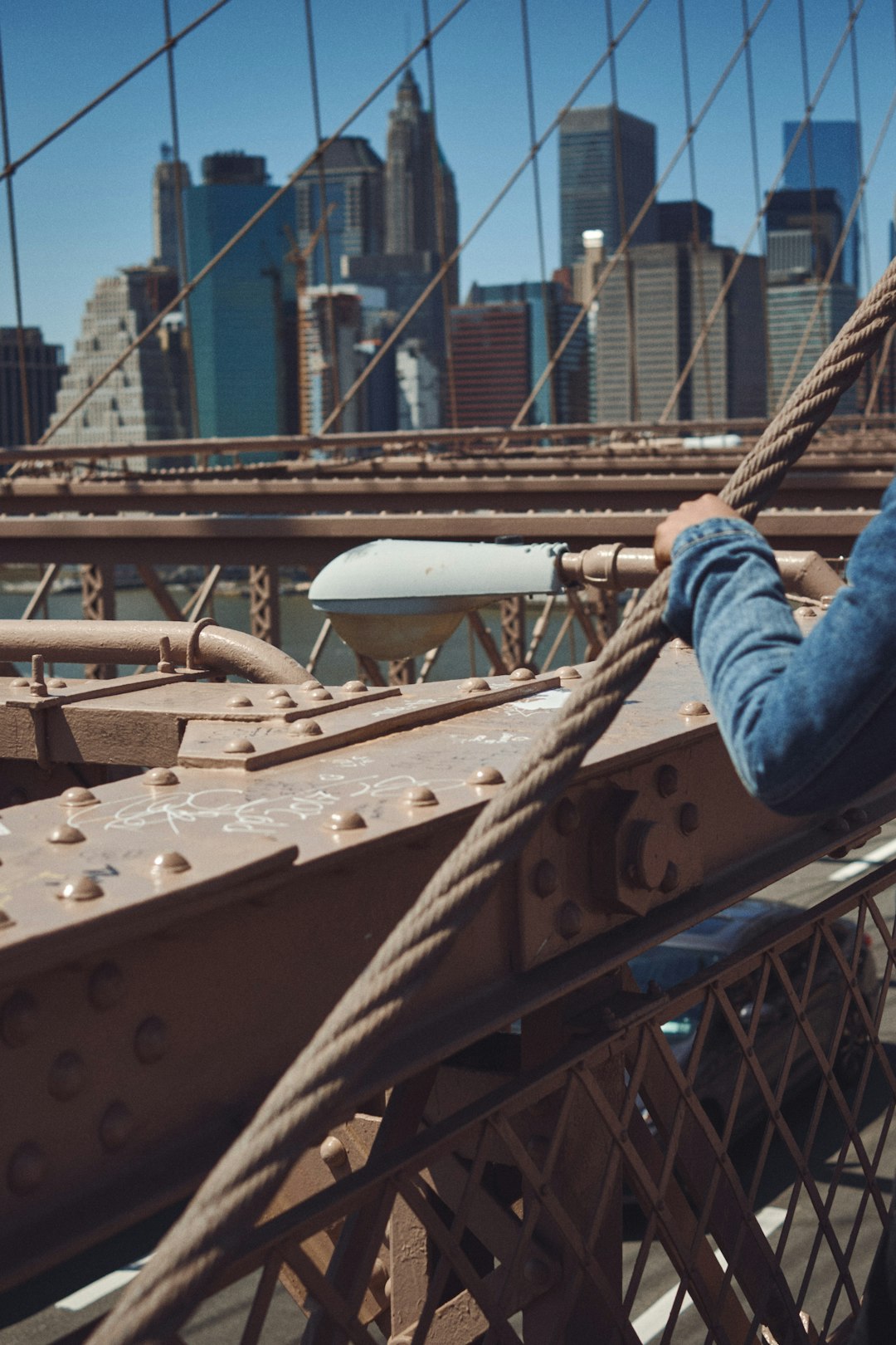 person in blue denim jeans and blue gloves riding on blue and white ship during daytime