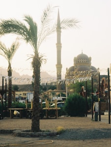 A serene landscape of Mecca with pilgrims in the foreground.