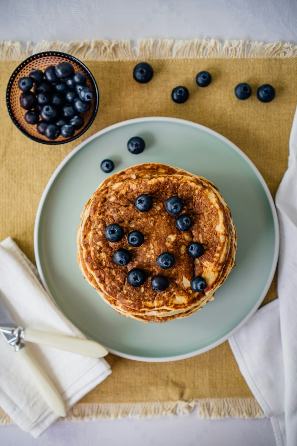 brown and black round pastry on white ceramic plate