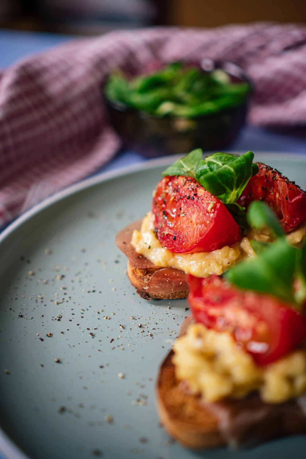 red tomato on white and blue ceramic plate