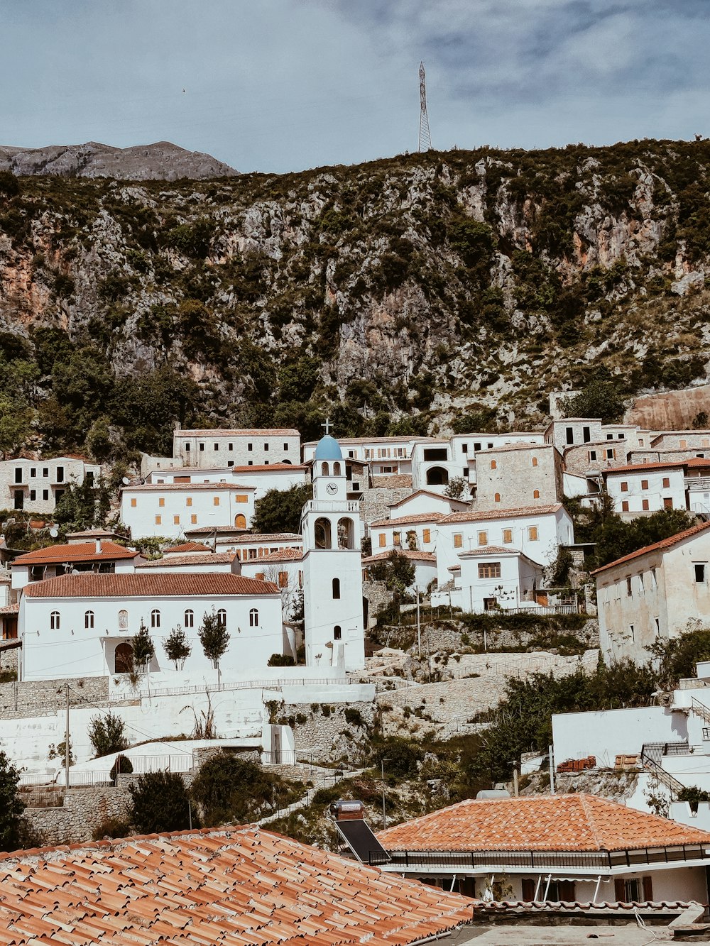 white and brown concrete buildings on brown rocky mountain during daytime