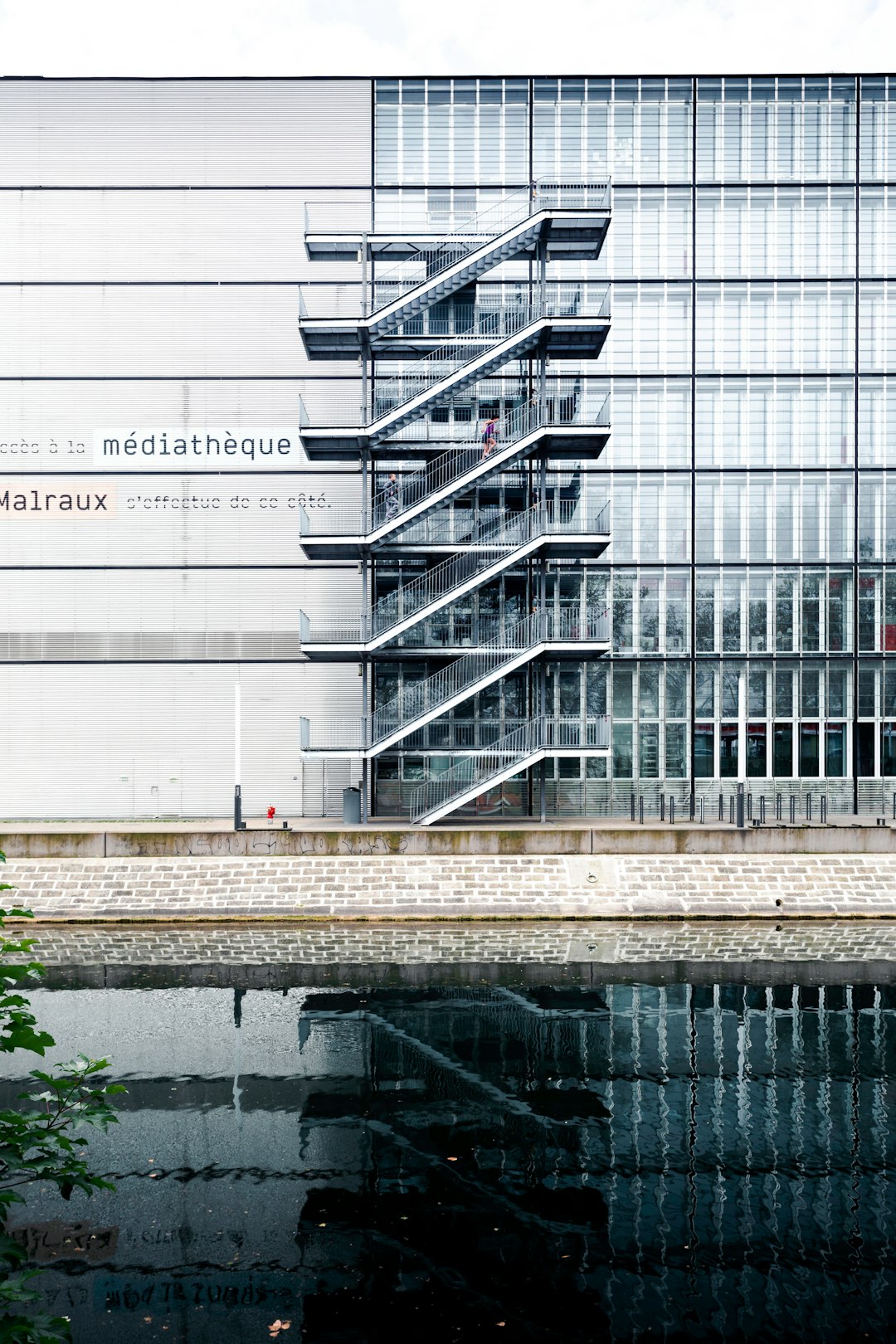 gray metal stairs near white concrete building during daytime