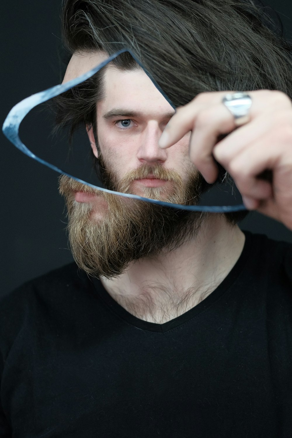 man in black crew neck shirt holding blue coated wire