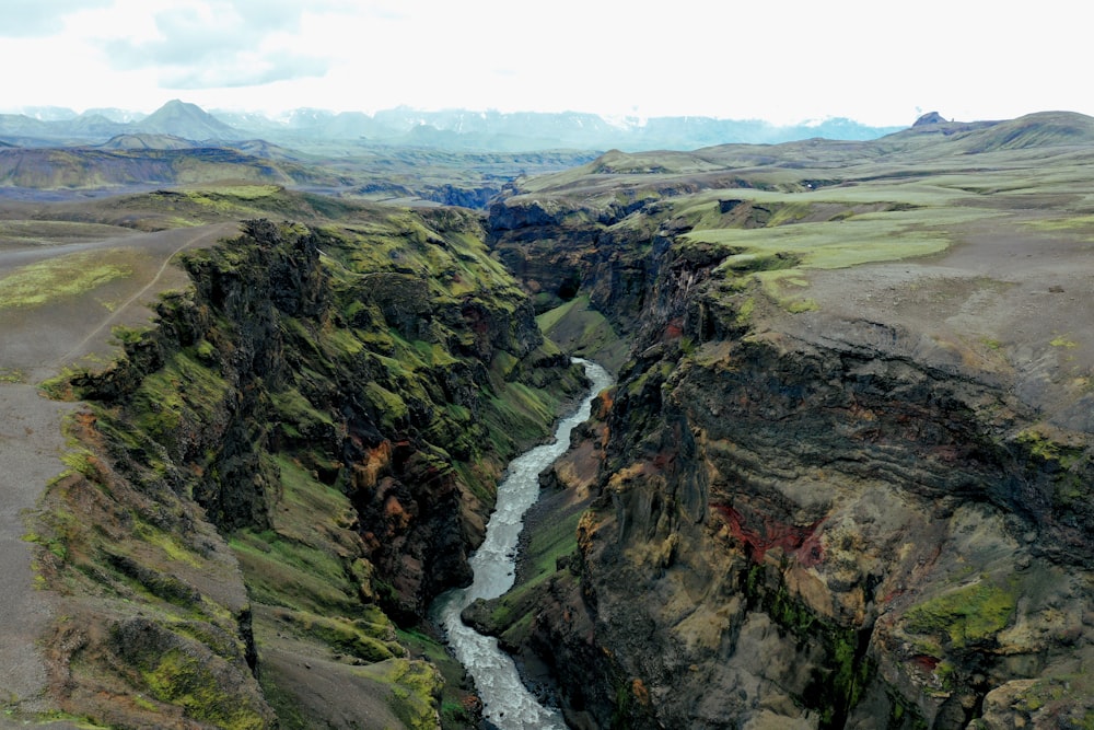 river between mountains during daytime