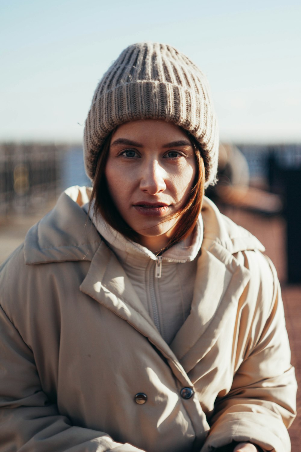 woman in gray knit cap and white zip up jacket