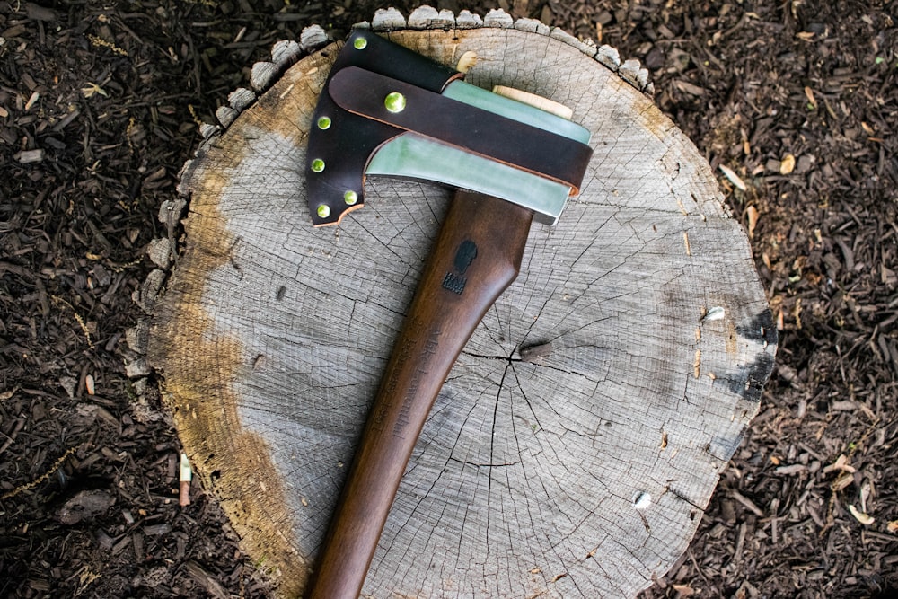 brown and black wooden handle knife on brown wooden round table