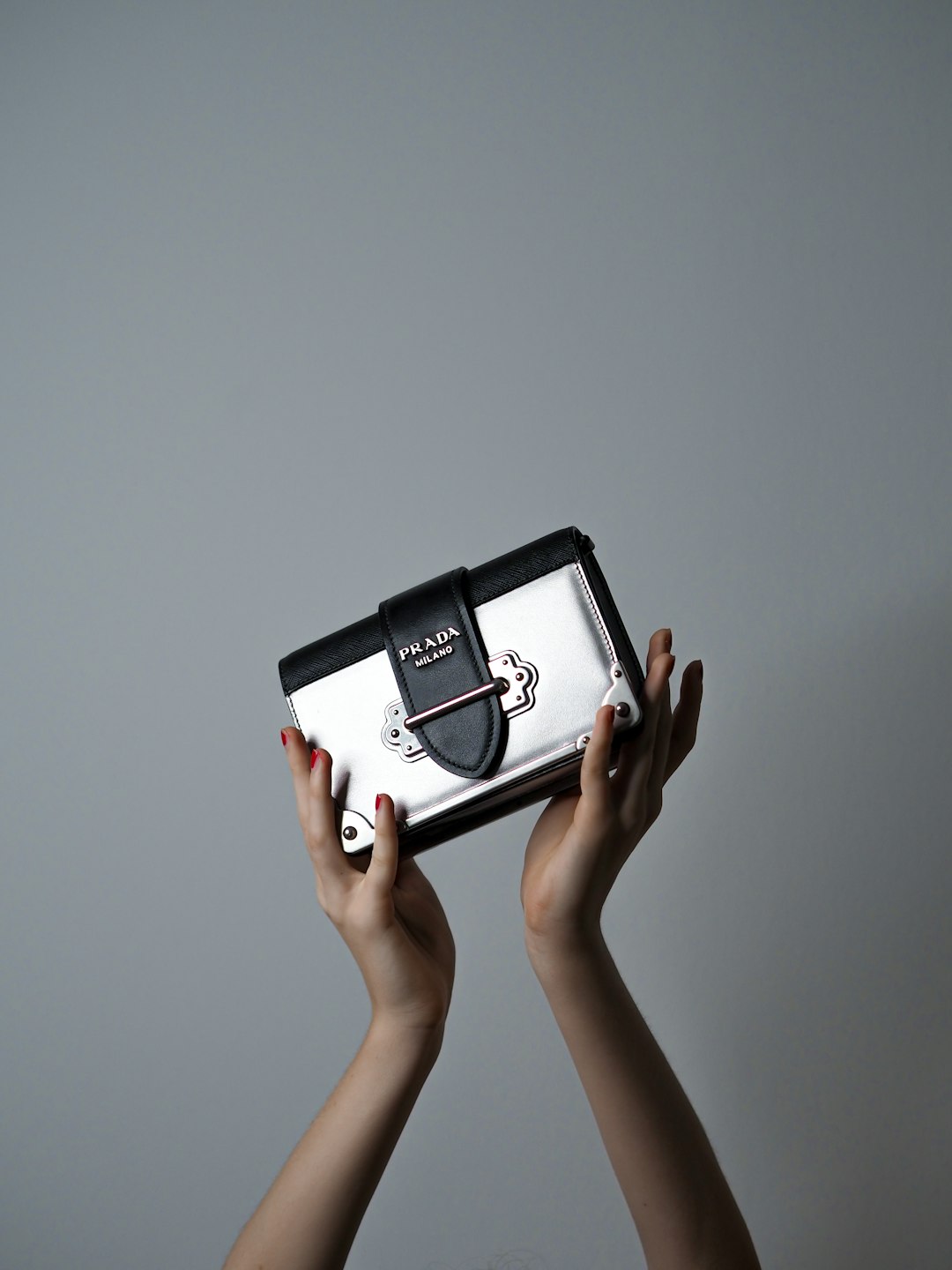 person holding black and white digital device