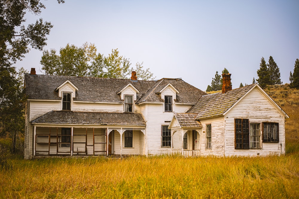 white and brown house near green grass field during daytime