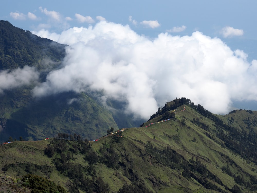 green mountain under white clouds during daytime