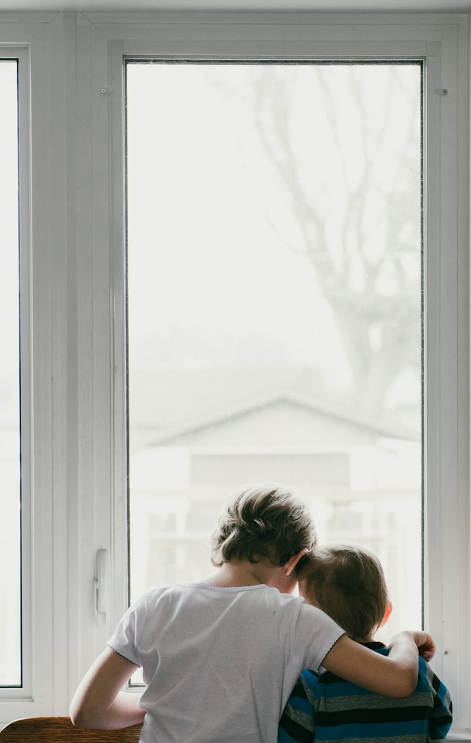 woman in white shirt looking at the window