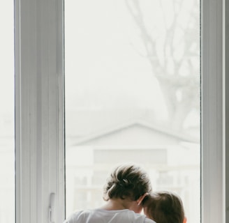 woman in white shirt looking at the window