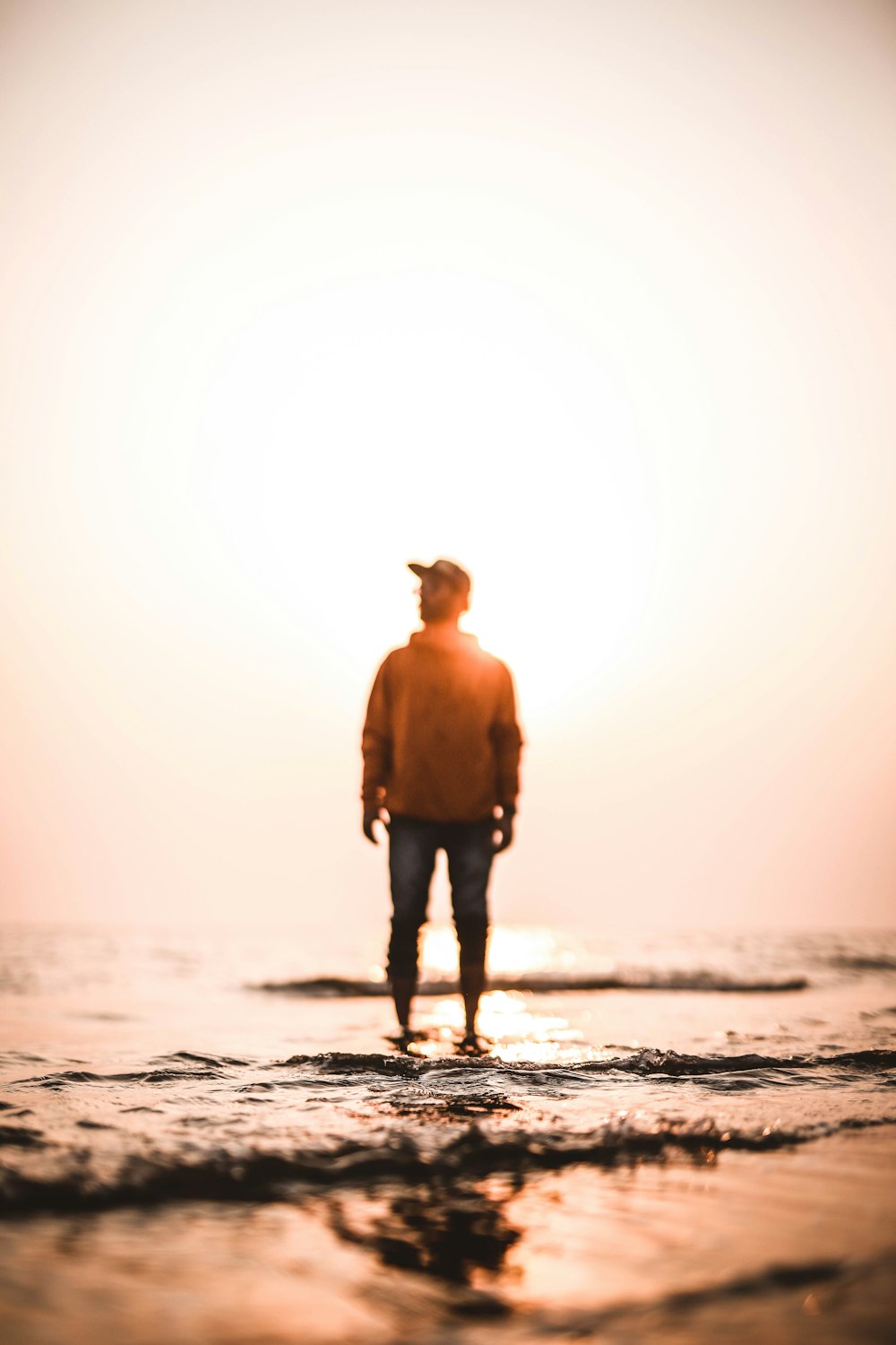 man in black shorts standing on beach during daytime