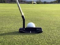 SAAG Inc image of white golf ball on green grass field