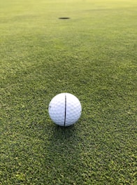 white golf ball on green grass field during daytime