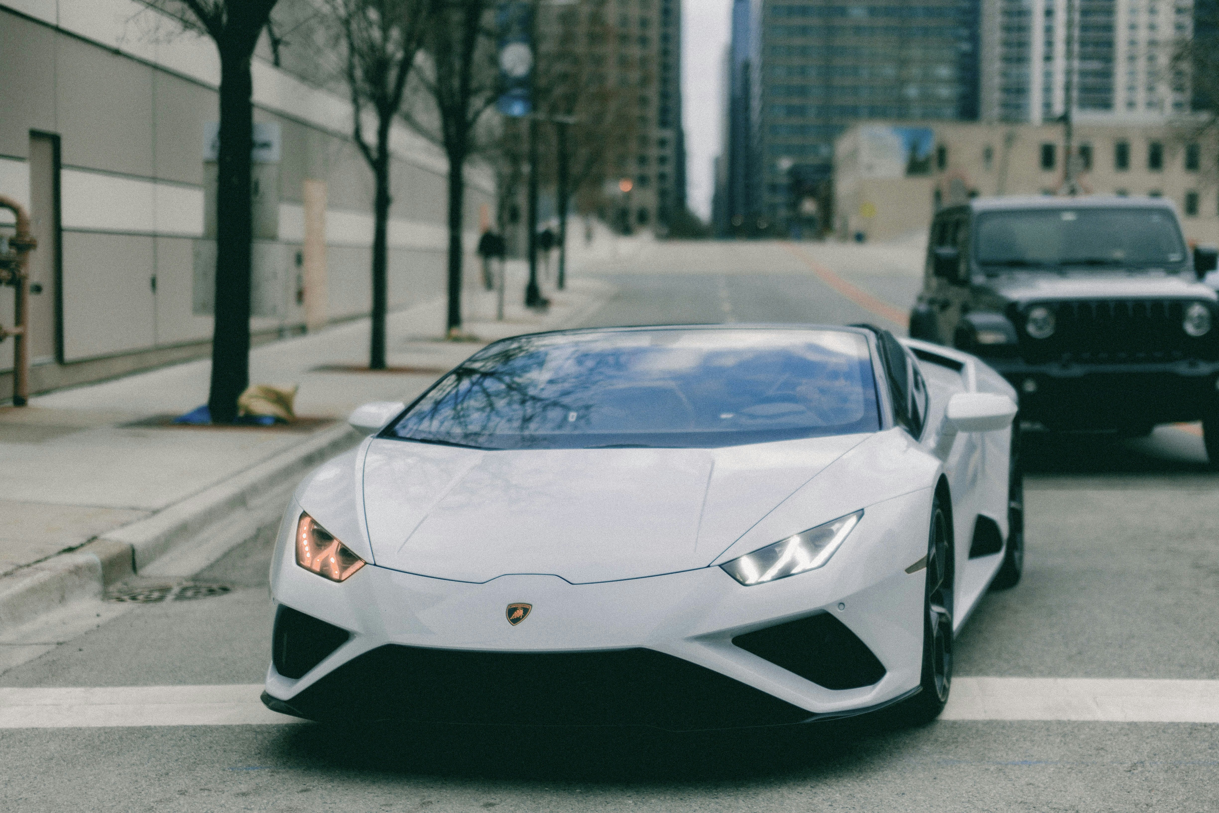 a white sports car parked on the side of the road