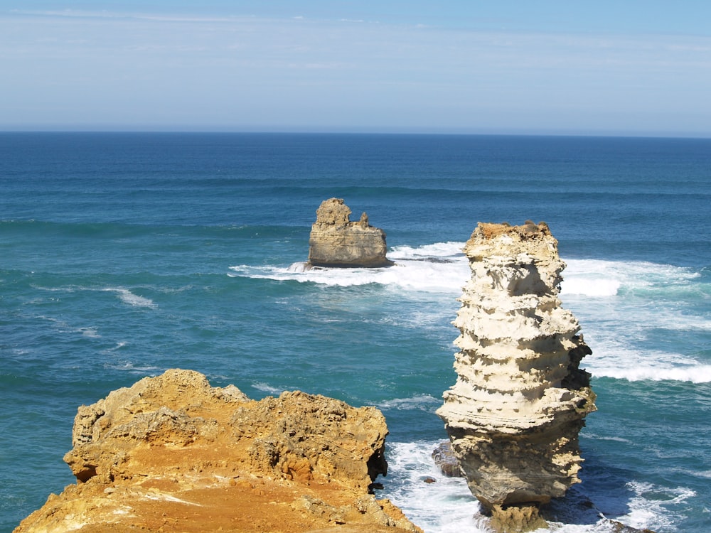 brown rock formation on sea during daytime