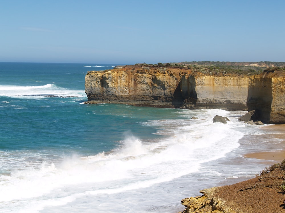 brown rock formation on sea shore during daytime