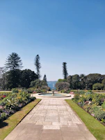 A sparkling clean garden fountain surrounded by well-maintained greenery.