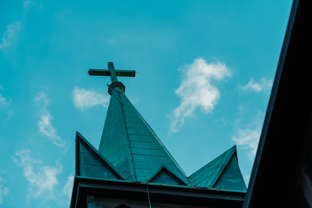 black cross on top of building under blue sky during daytime