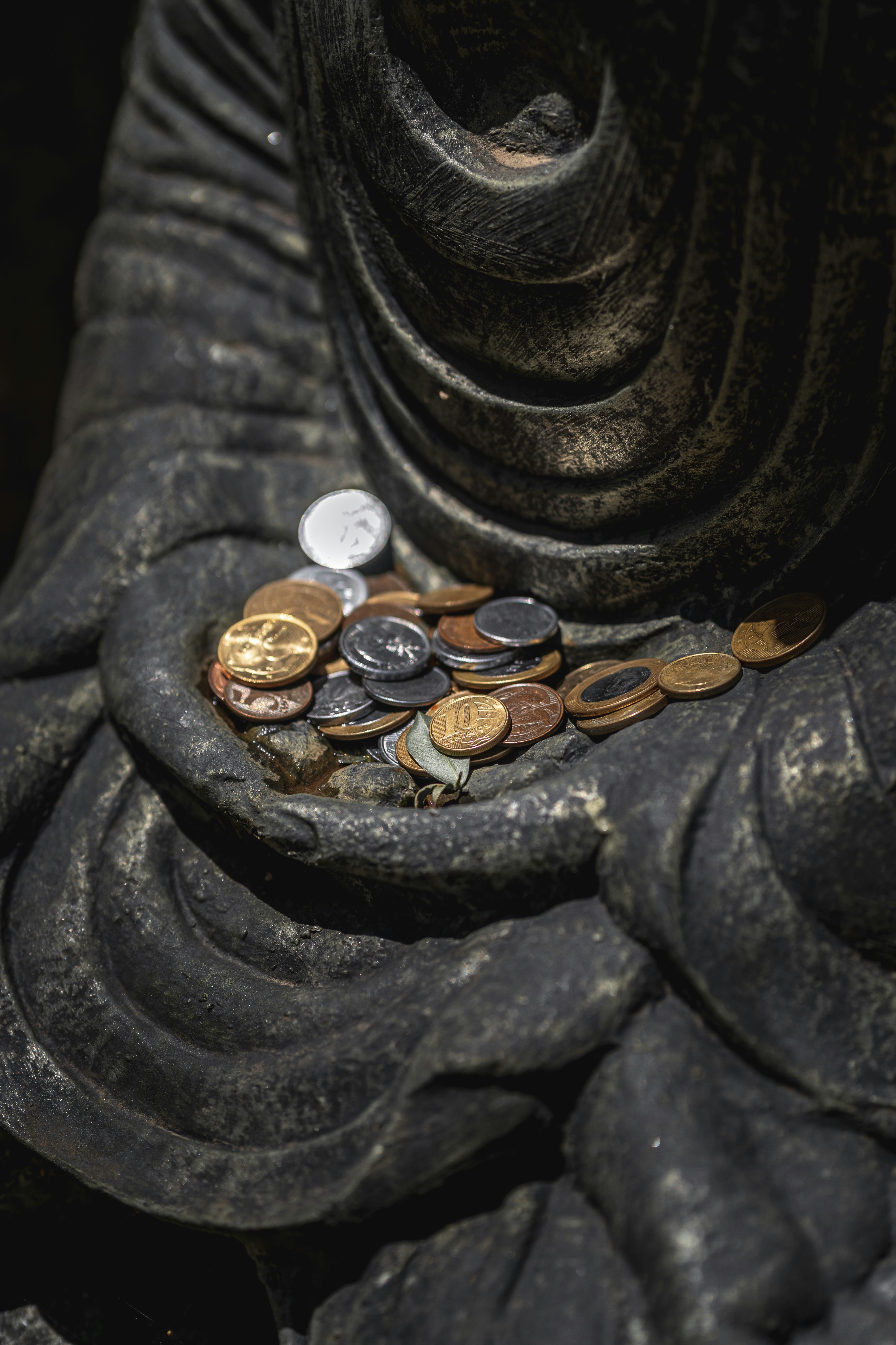 silver round coins on black surface