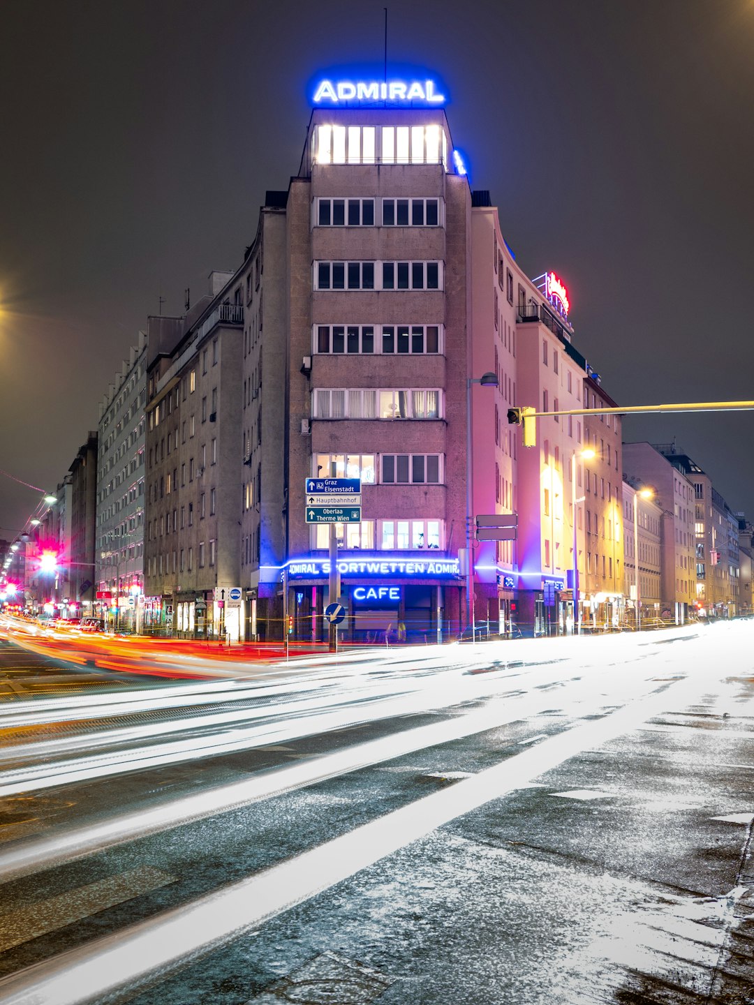 time lapse photography of cars on road near brown concrete building during nighttime