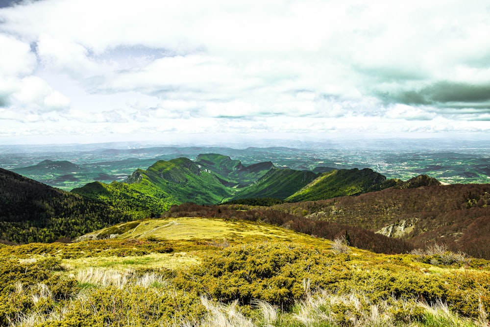 green mountains under white clouds during daytime