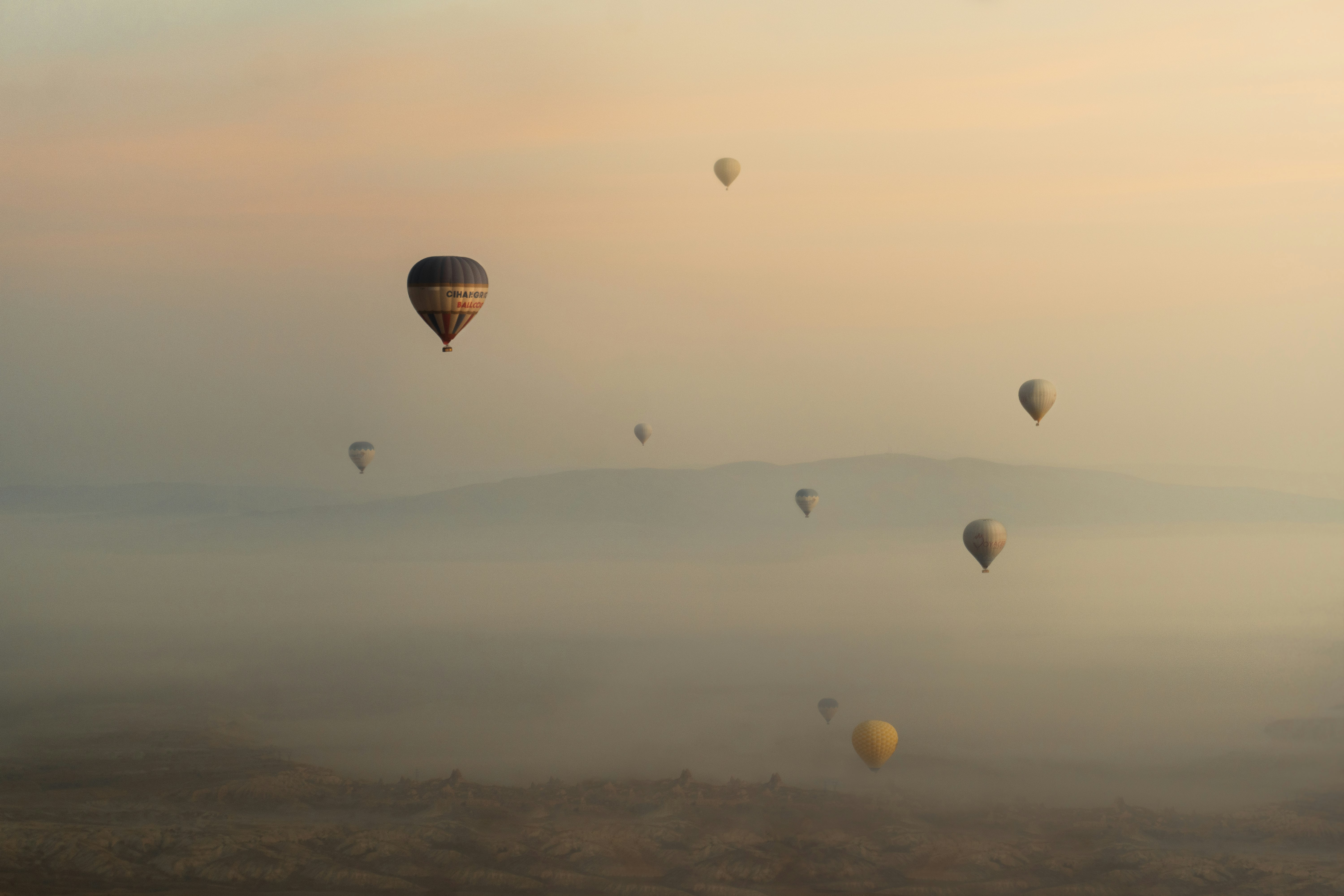 hot air balloons in the sky during sunset