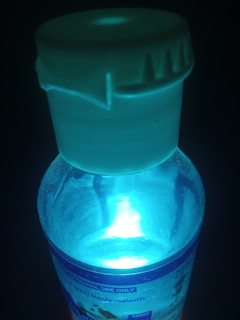 A close-up of a glowing product in a dark environment.