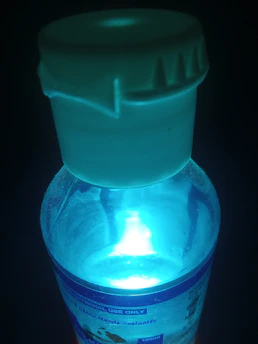 A sleek bottle of nutraceutical supplements with a glowing blue light effect.