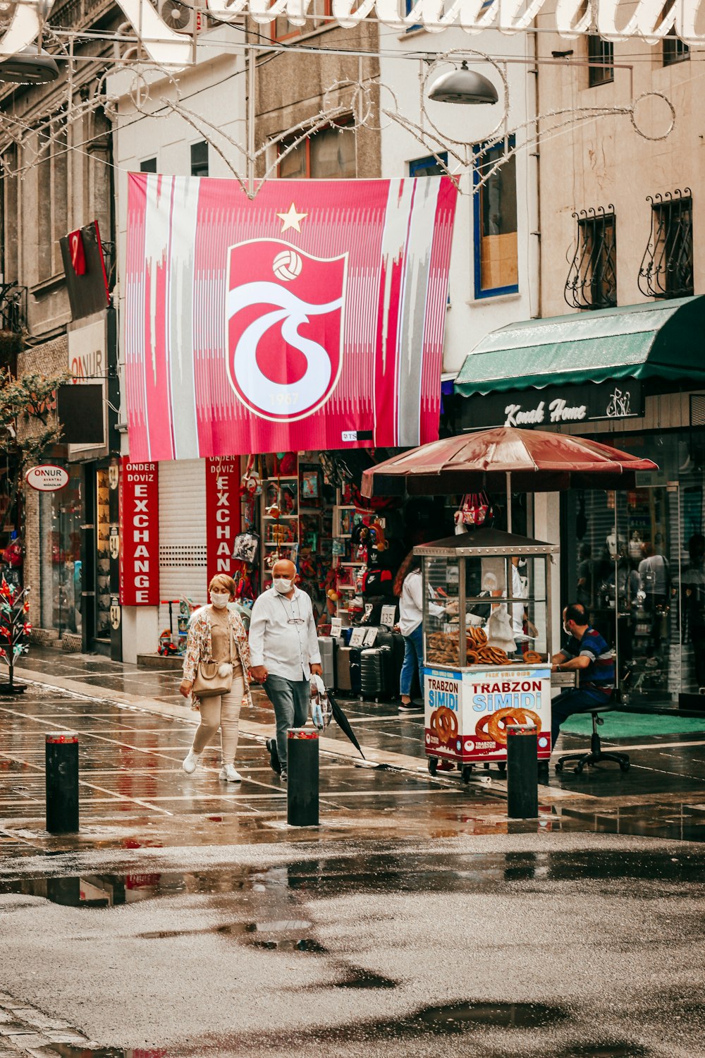 man and woman walking on sidewalk during daytime