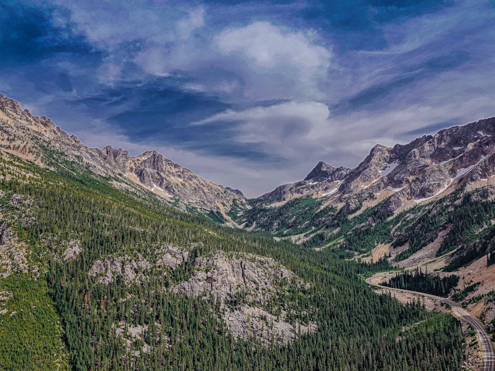 green and brown mountains under blue sky and white clouds during daytime