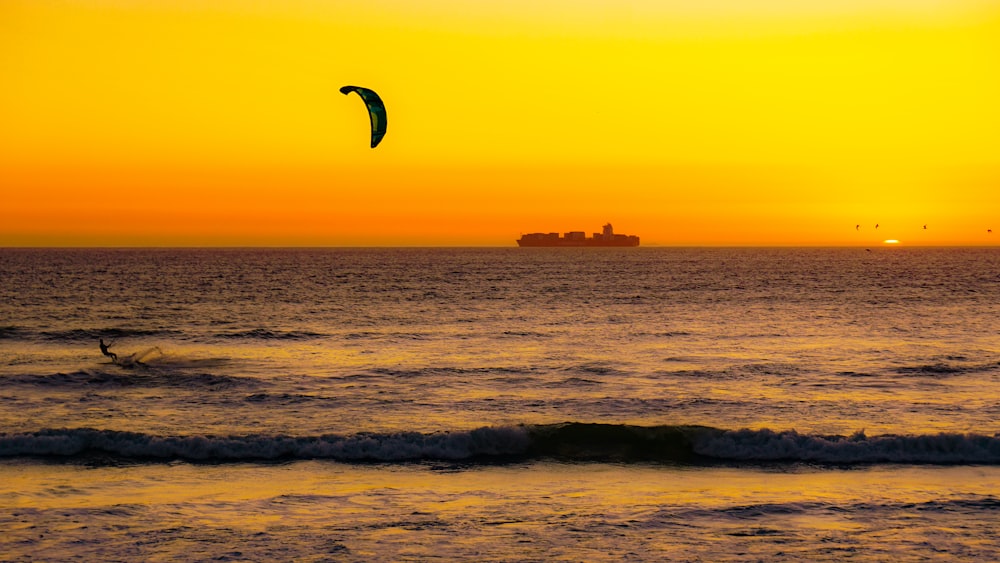 person surfing on sea waves during sunset