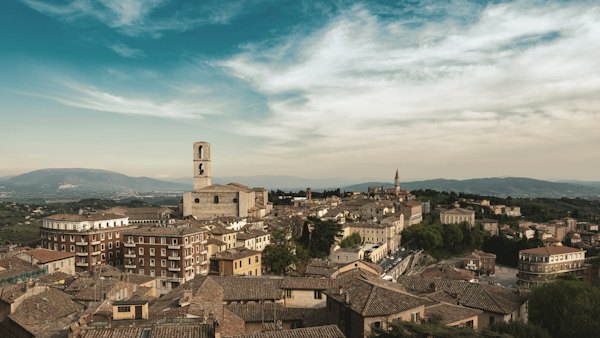 Brown concrete building under blue sky during daytime — Perugia, Italy