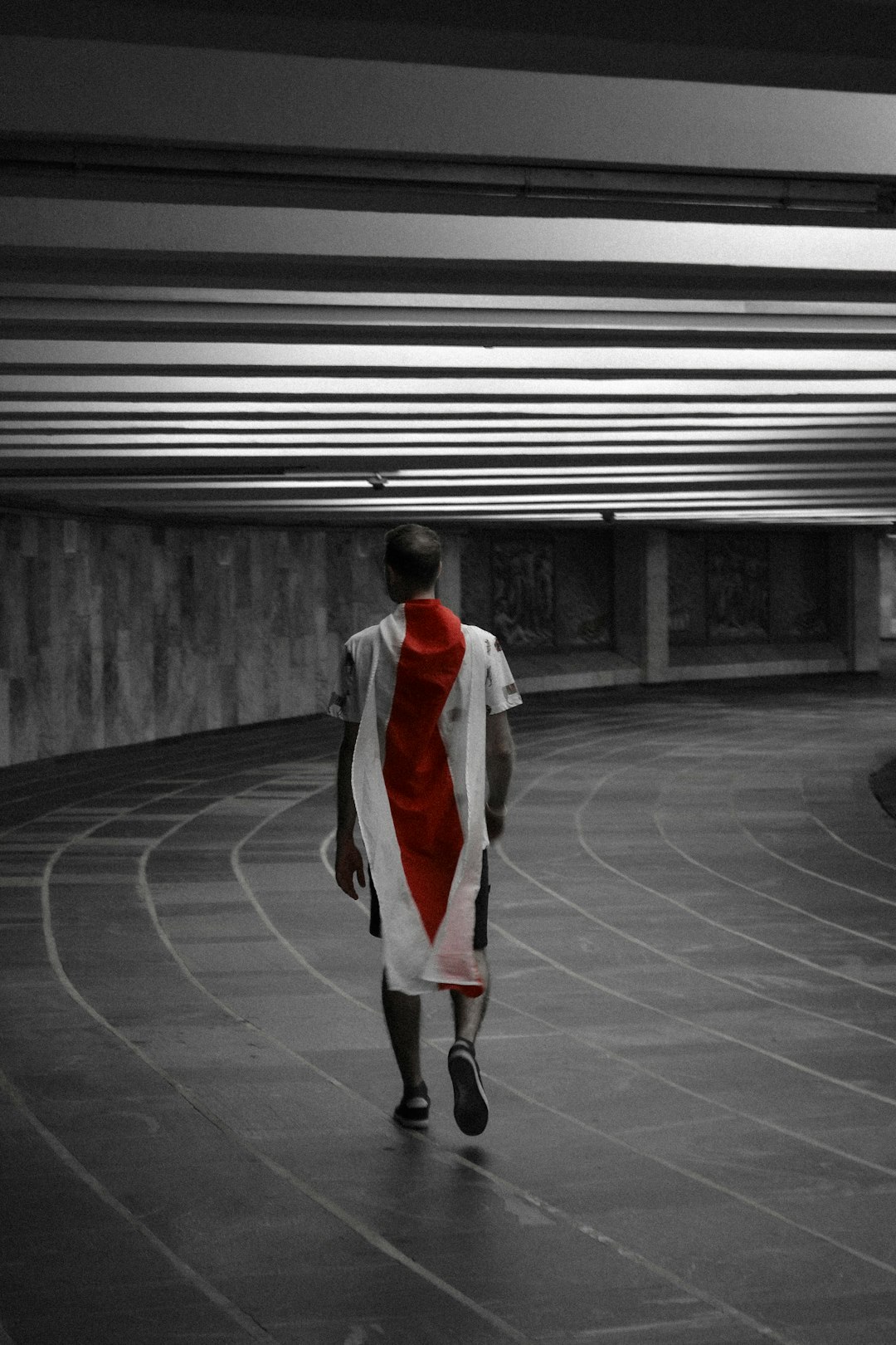 man in white and black jacket walking on sidewalk