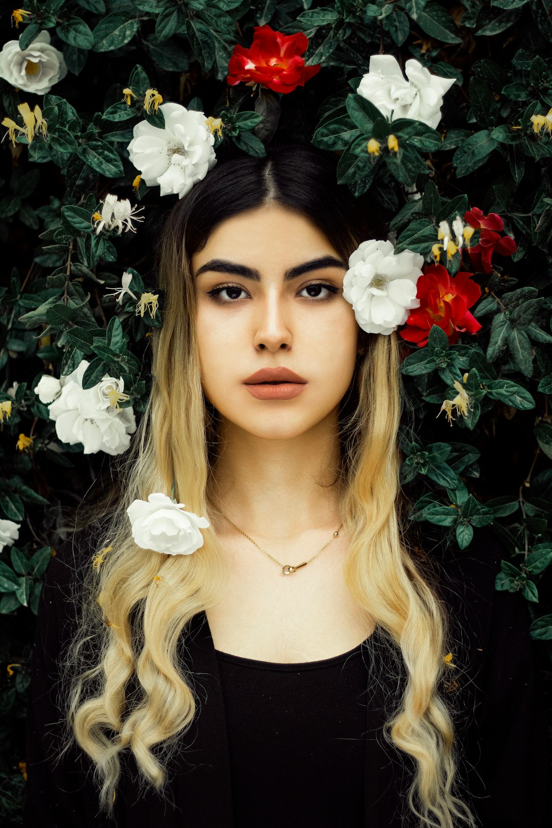 woman in black crew neck shirt with white flower on her ear