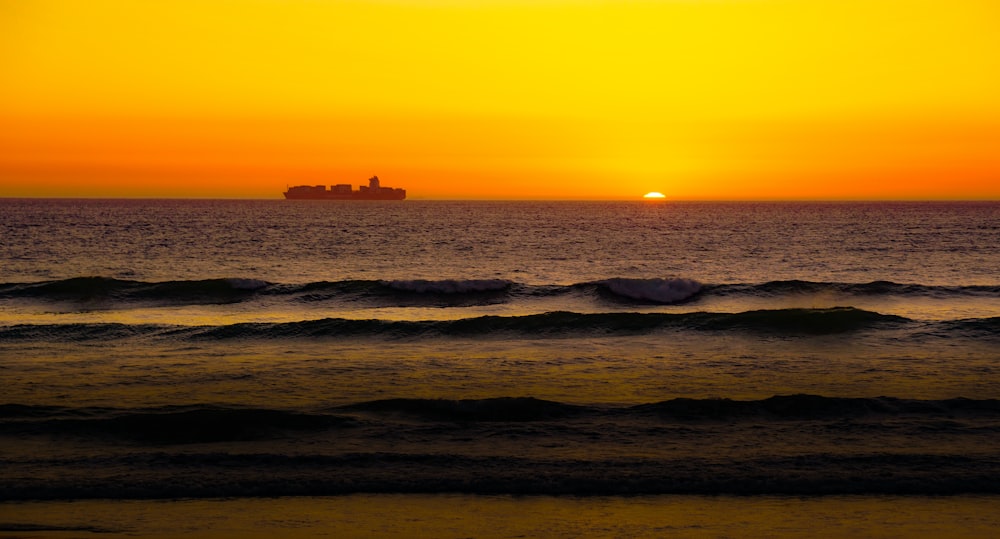 ocean waves crashing on shore during sunset