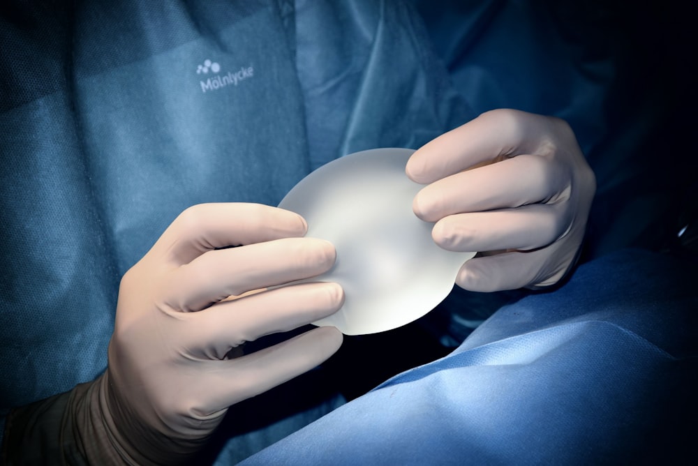 person holding white heart shaped ornament