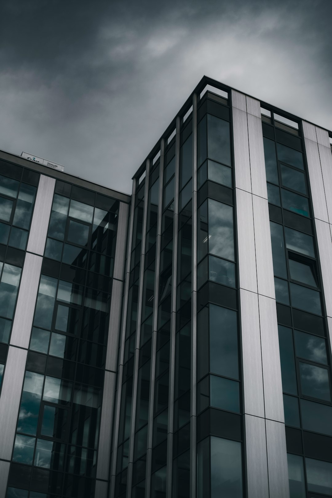 gray concrete building under cloudy sky during daytime